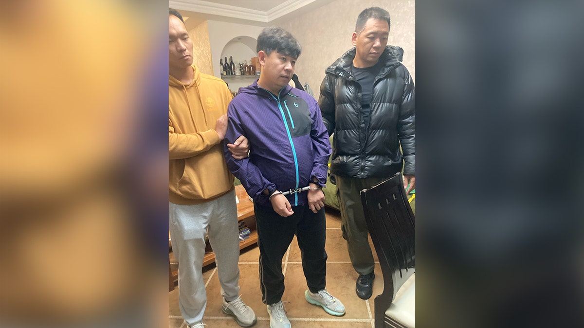 Pastor Sun Cong of Zion Church wearing handcuffs