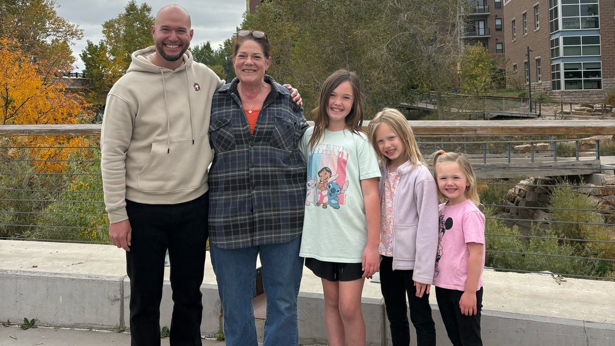 Pastor Neal Seiwert and his family posing with delivery driver Suzanna in Colorado.