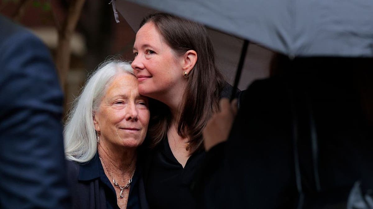 James Comey's wife and daughter kiss outside courthouse