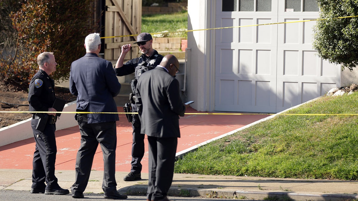 Police speaking in front of the home where four allegedly died