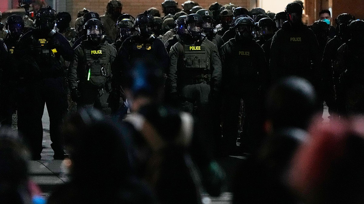 Law enforcement officers standoff against demonstrators