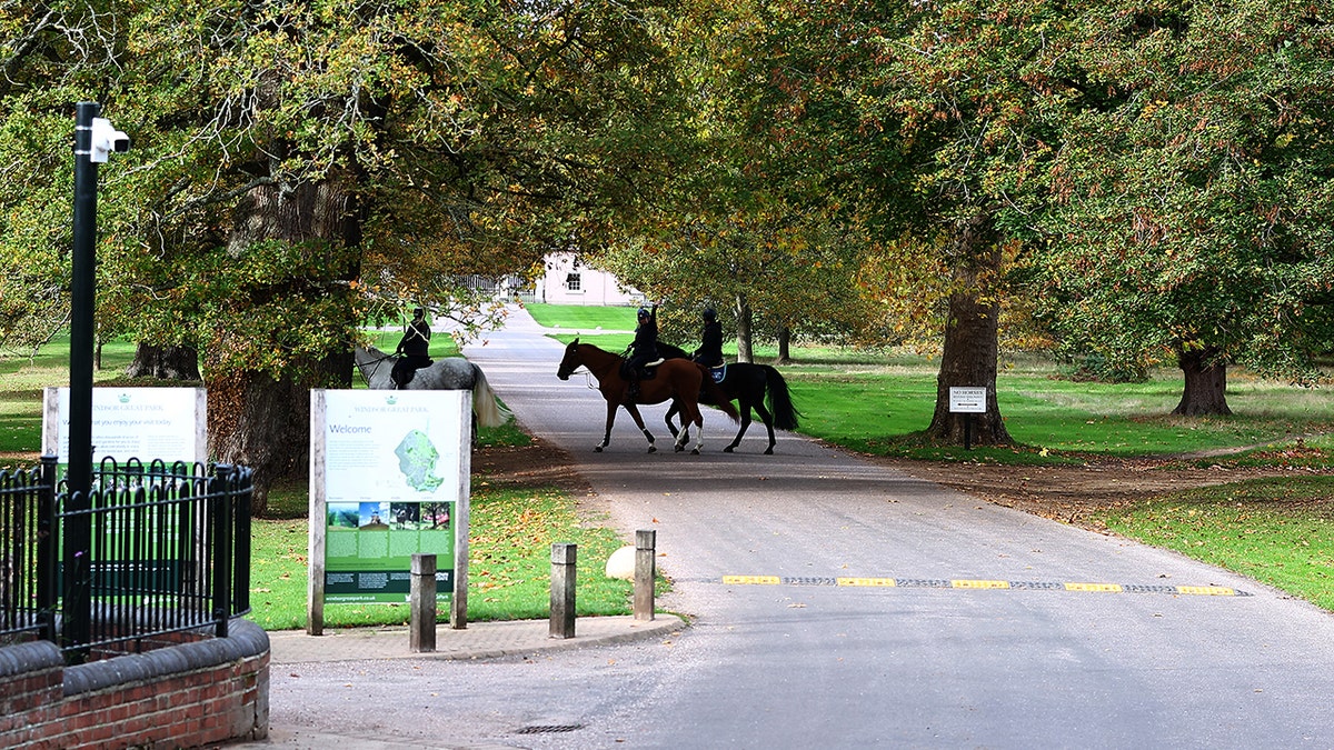 Men on horseback near the royal residence.