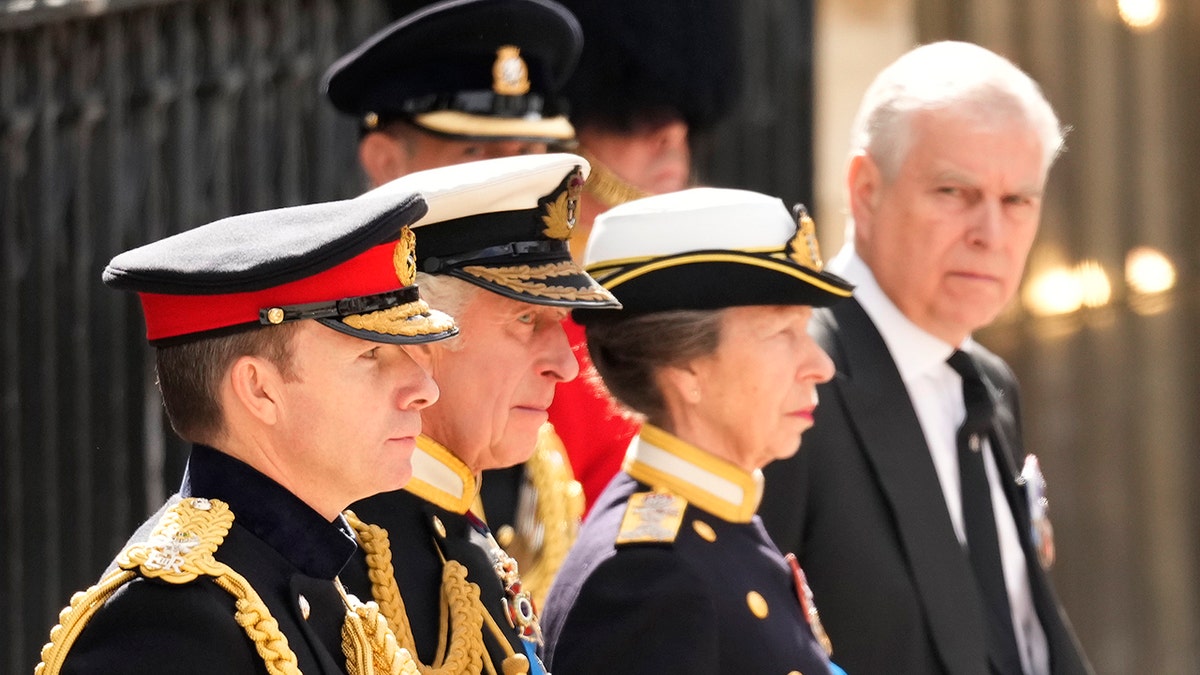 Prince Andrew looking sternly at his siblings during the funeral of Queen Elizabeth II.