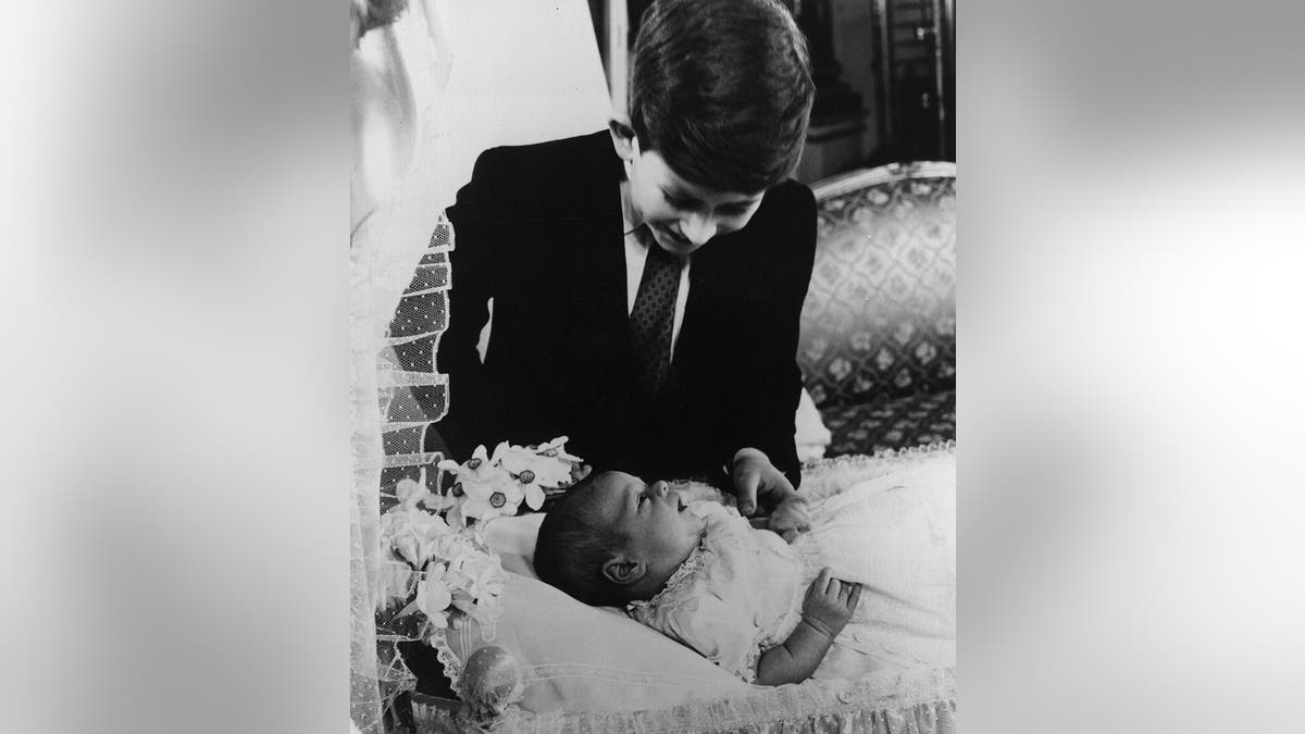 Prince Charles admiring his baby brother Prince Andrew.