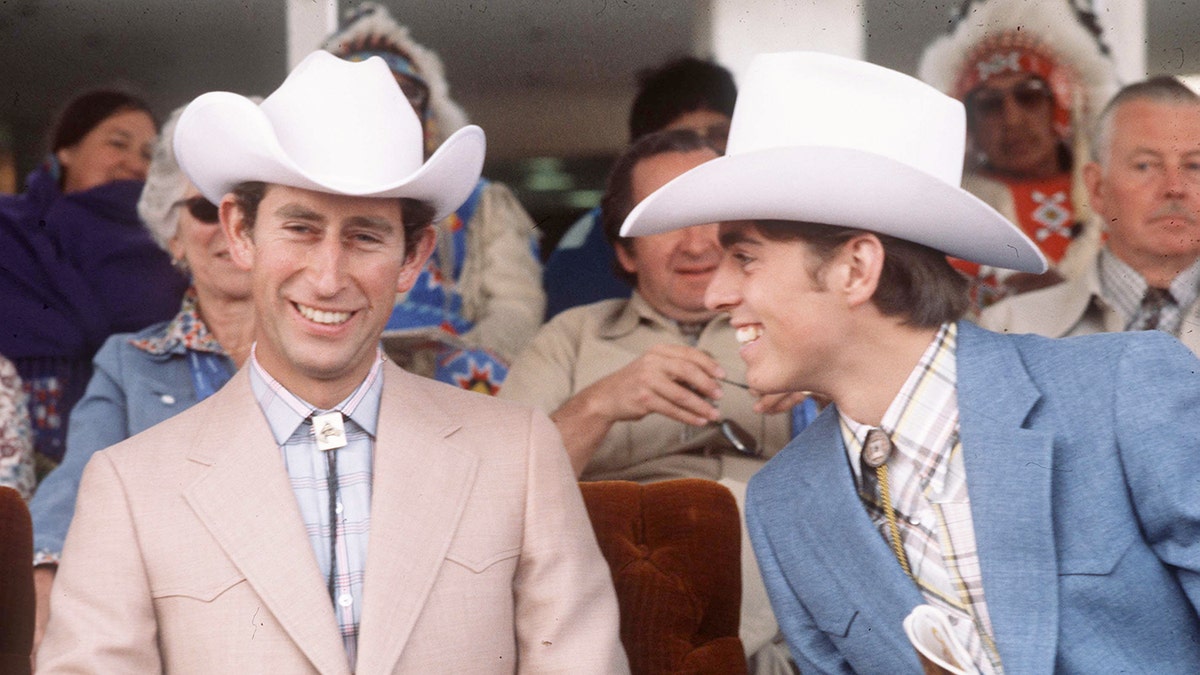 Prince Charles and Prince Andrew smiling wearing matching Western wear.