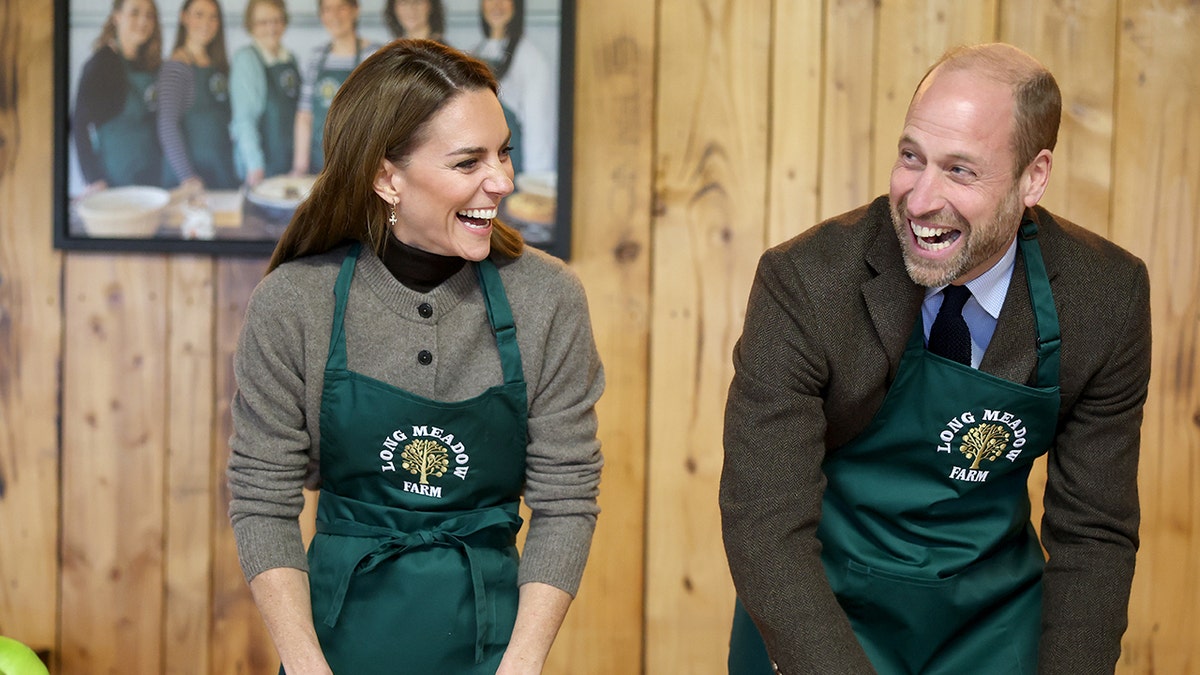 Kate Middleton and Prince William laughing as they bake together.