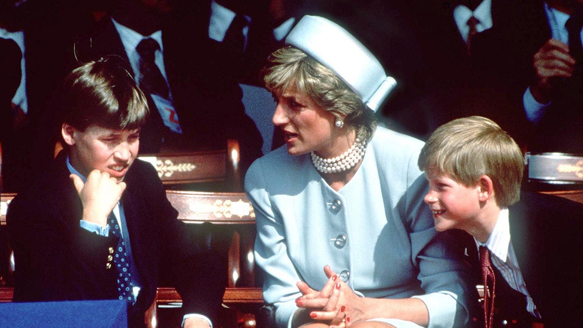 Princess Diana chatting with Prince William as Prince Harry smiles and looks on.