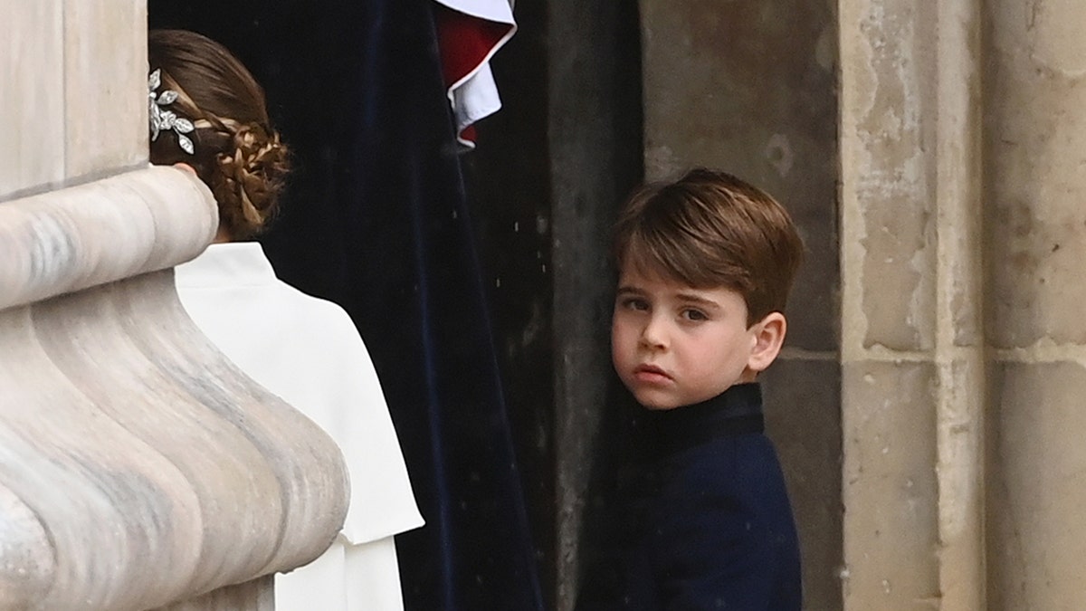 Prince Louis walking behind his sister Princess Charlotte.