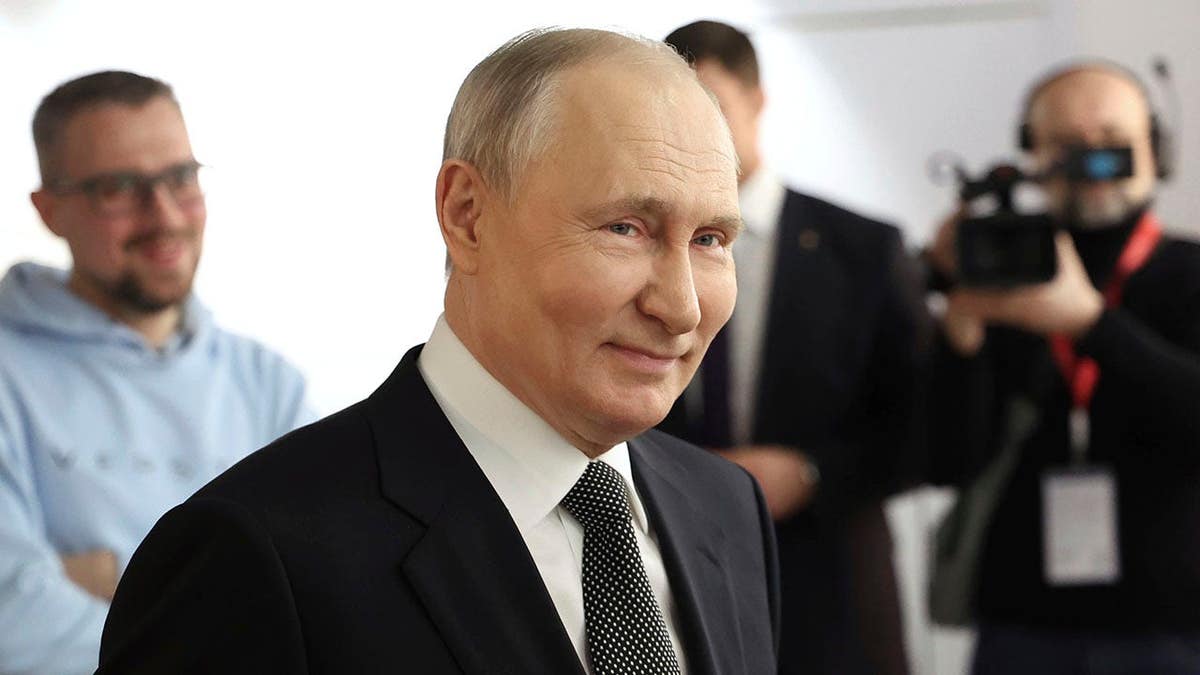 Russian President Vladimir Putin smiles