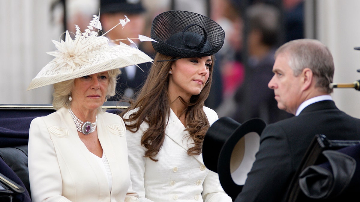 Kate Middleton sitting in a royal carriage with Queen Camilla and Prince Andrew.