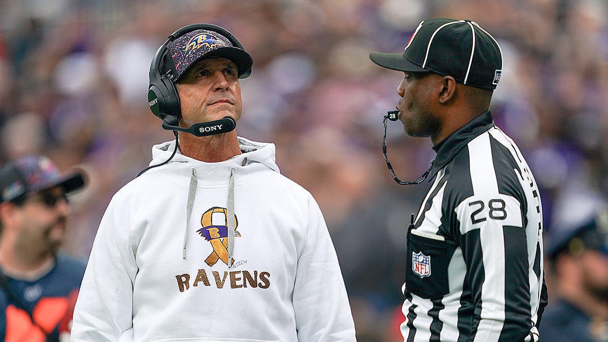 John Harbaugh looks on
