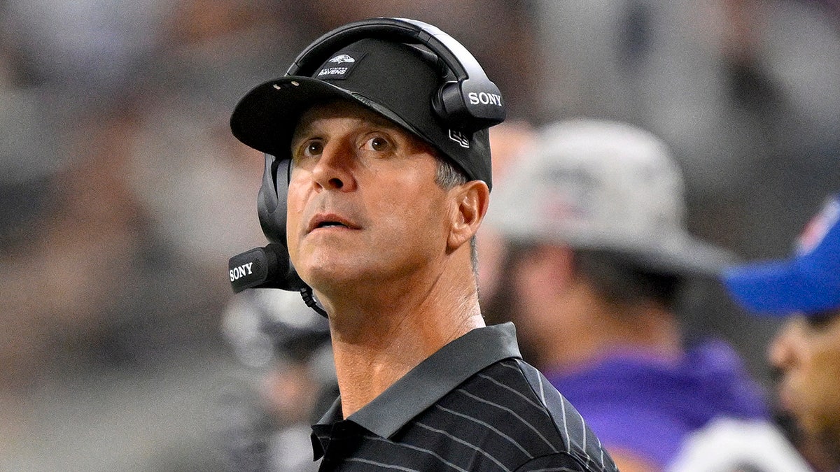 John Harbaugh looks on