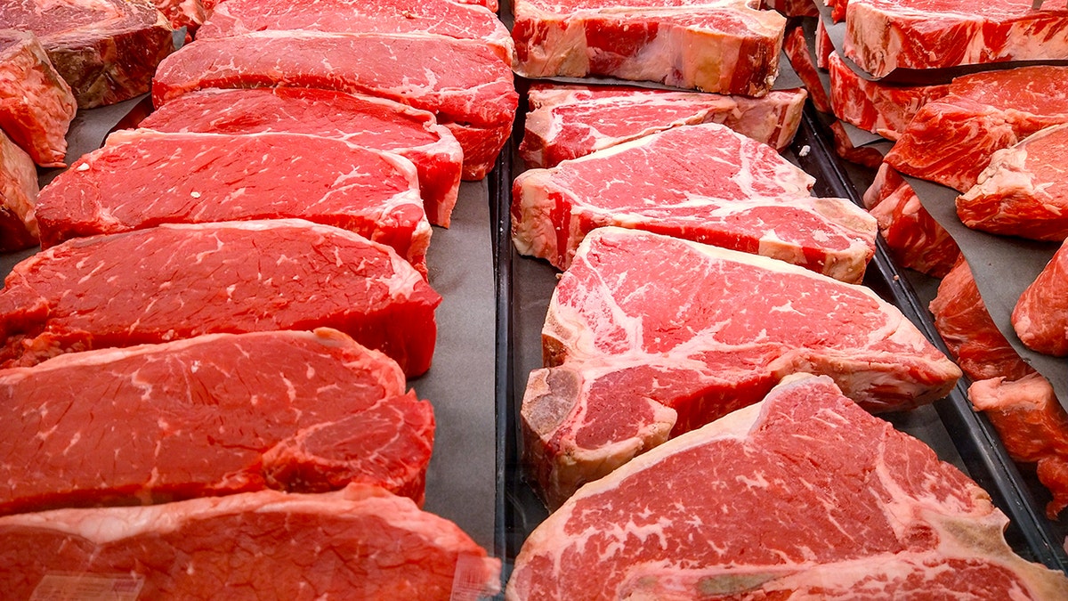 Rows of raw steak are seen.
