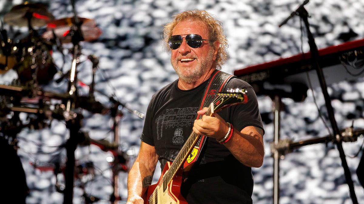 Sammy Hagar playing guitar in a black t-shirt last month