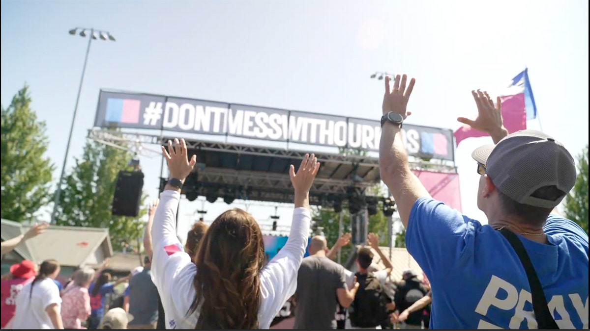 Christian worshippers raising hands at worship event