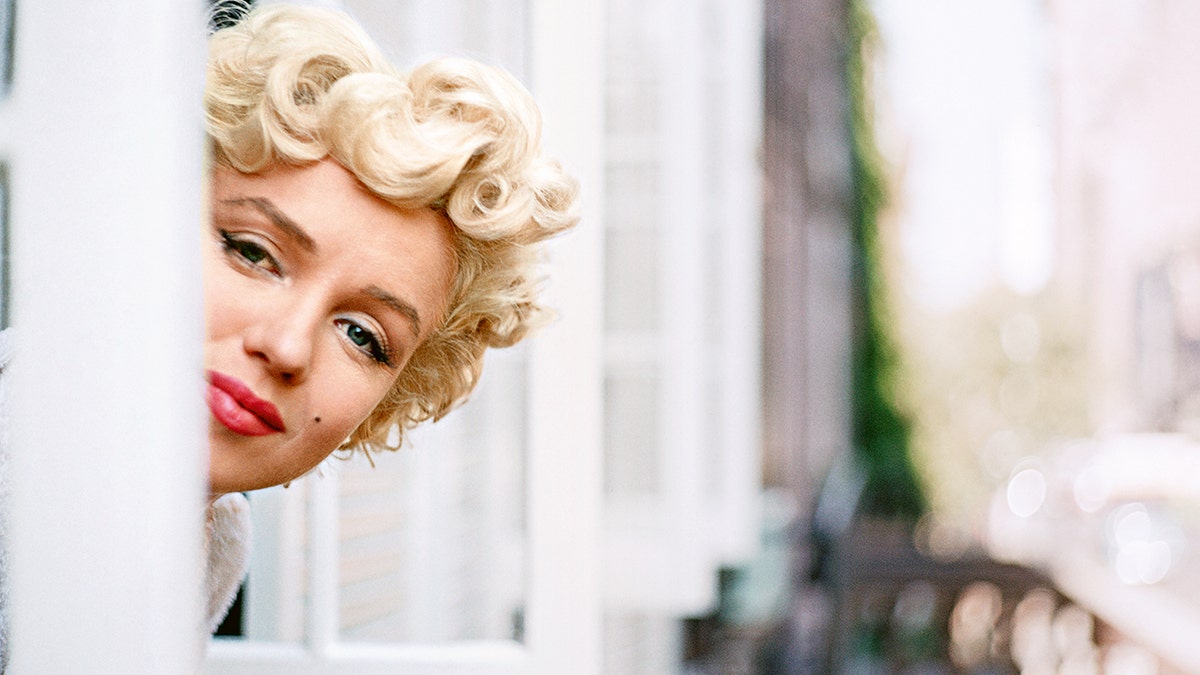Marilyn Monroe peeking from a window.