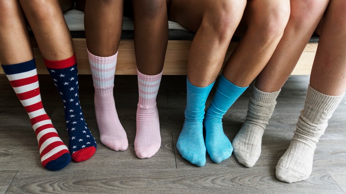group of friends wearing colorful socks
