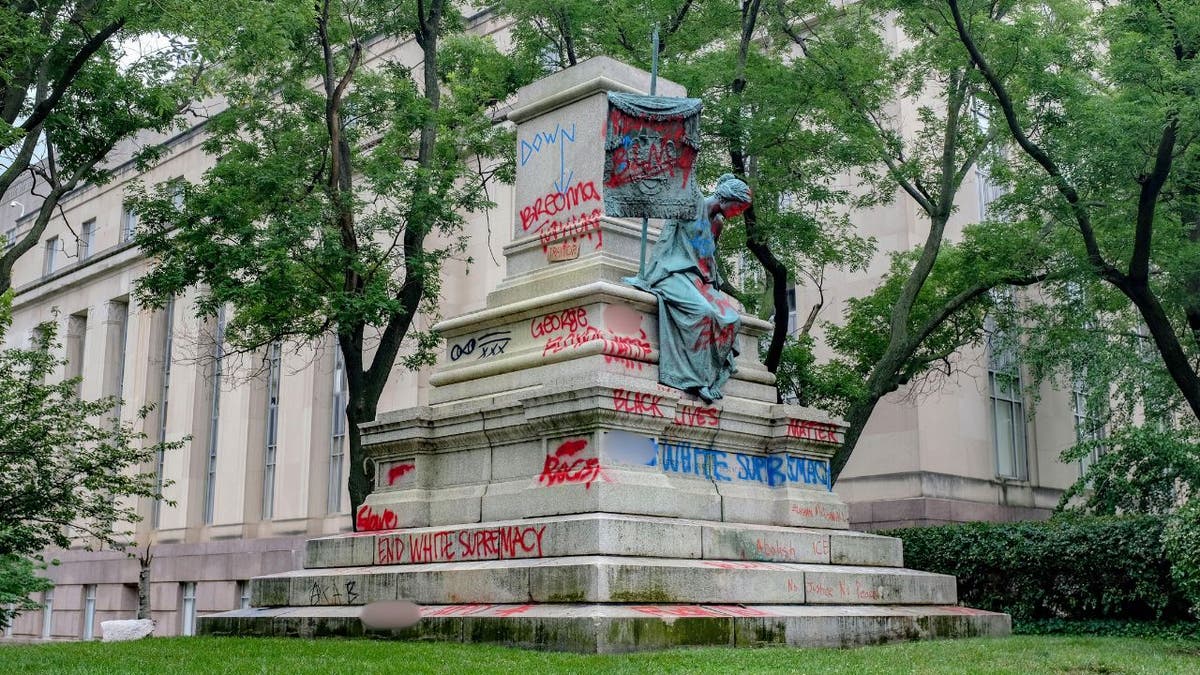 Graffiti-covered pedestal where Confederate Gen. Albert Pike statue was toppled in Washington, D.C., in June 2020.