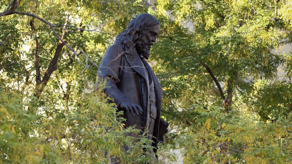Side view of the restored statue of Confederate Gen. Albert Pike surrounded by trees in Washington, D.C.