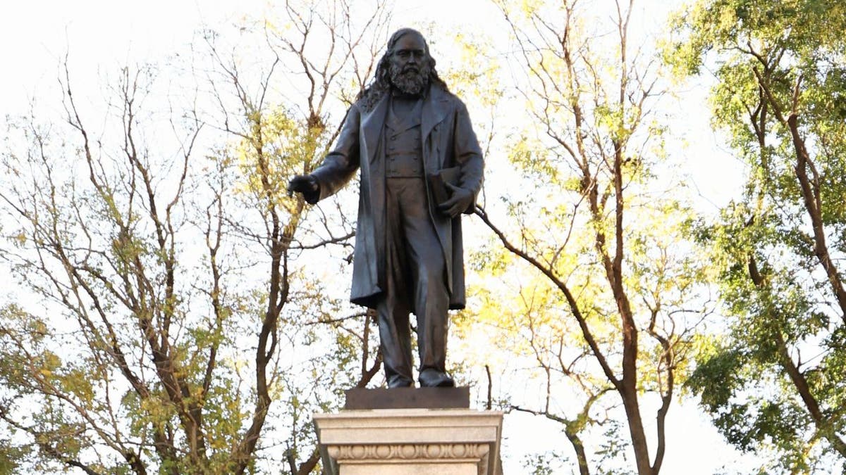 Reinstalled statue of Confederate Gen. Albert Pike in Washington, D.C., seen among trees.