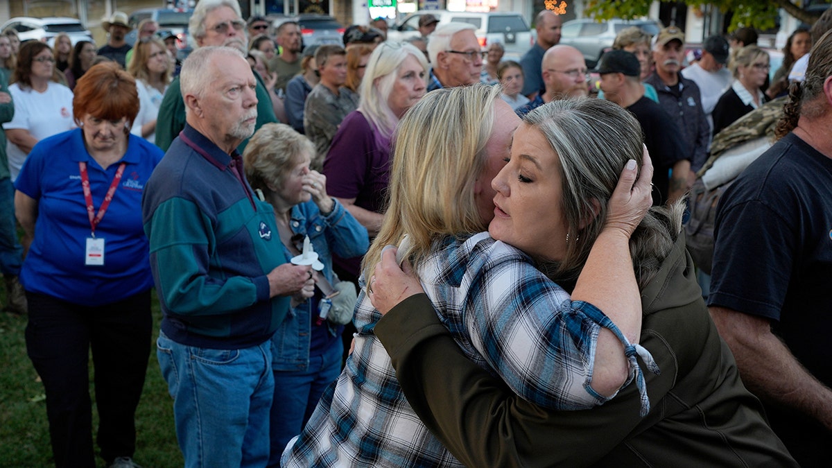 People embrace at vigil for victims of Tennessee plant explosion