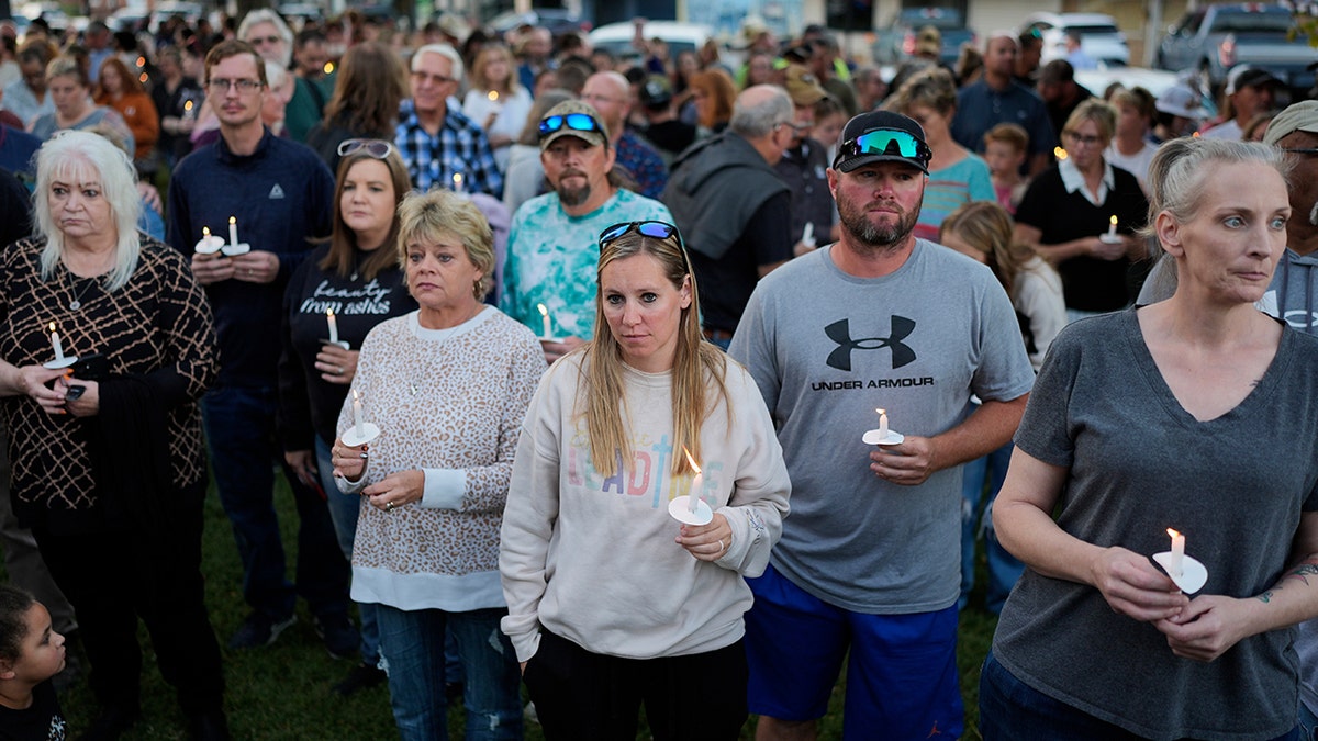 People hold candles during vigil for Tennessee plant explosion victims