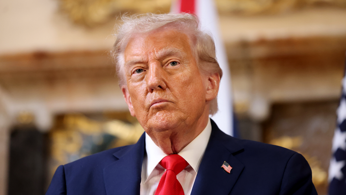 Trump listens during UK news event