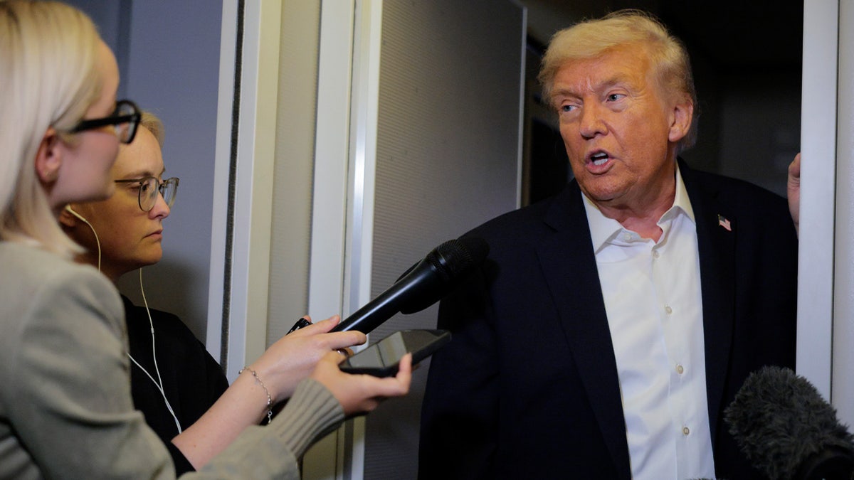 Trump speaks to reporters aboard AF1