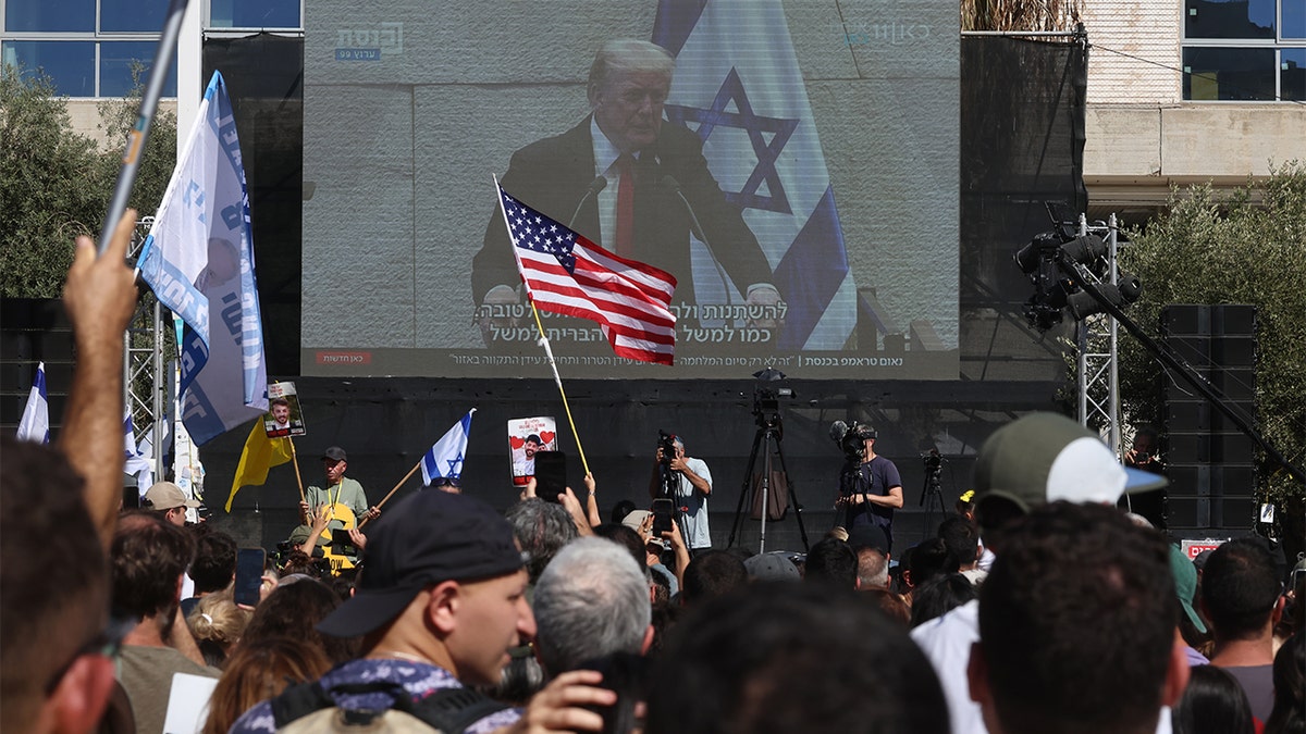 Israel, American flags wave in front of video of Trump speaking
