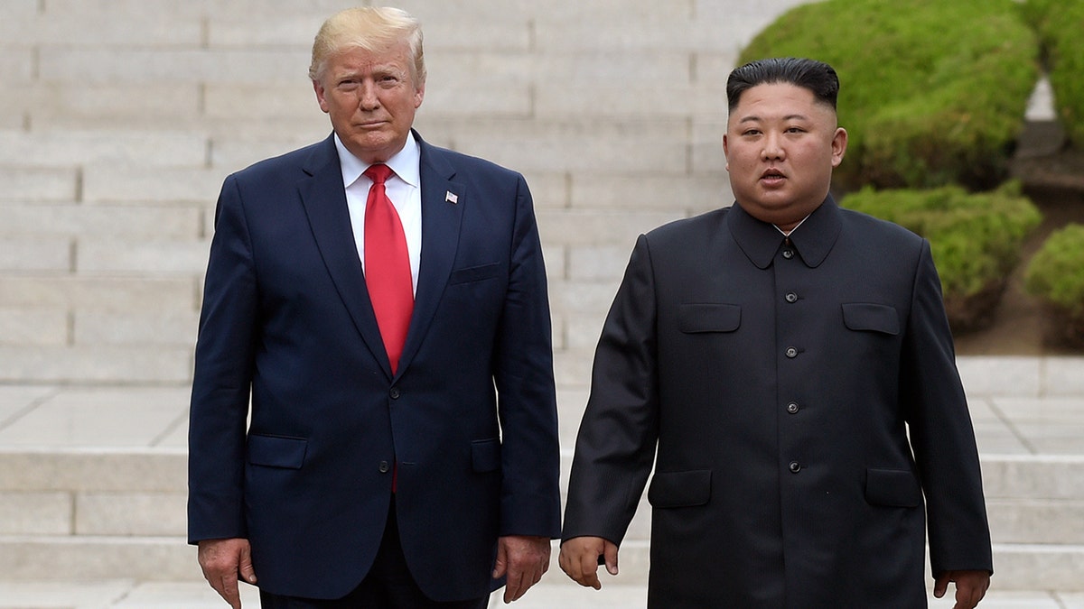 President Donald Trump stands by Kim Jong Un during 2019 meeting
