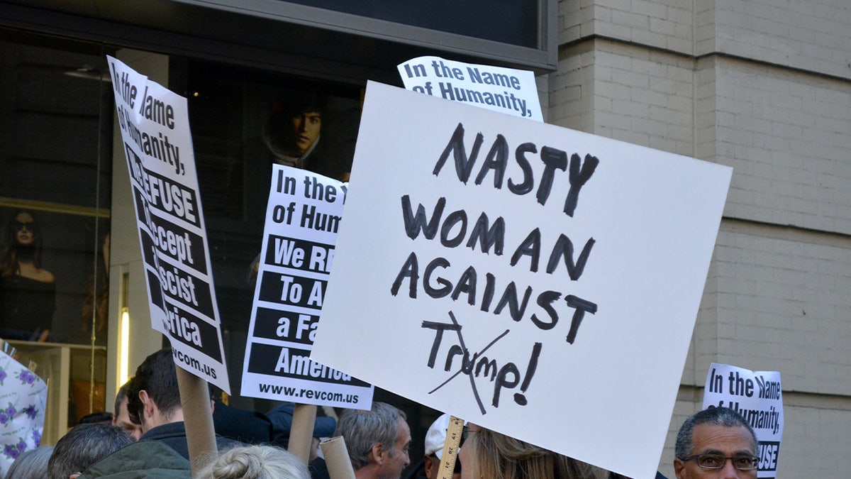 Nasty woman against Trump sign