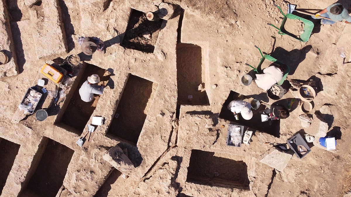 Archaeologists uncover 2,200-year-old ancient tombs in Colossae, Turkey 1 Aerial close-up of archaeologists working near graves