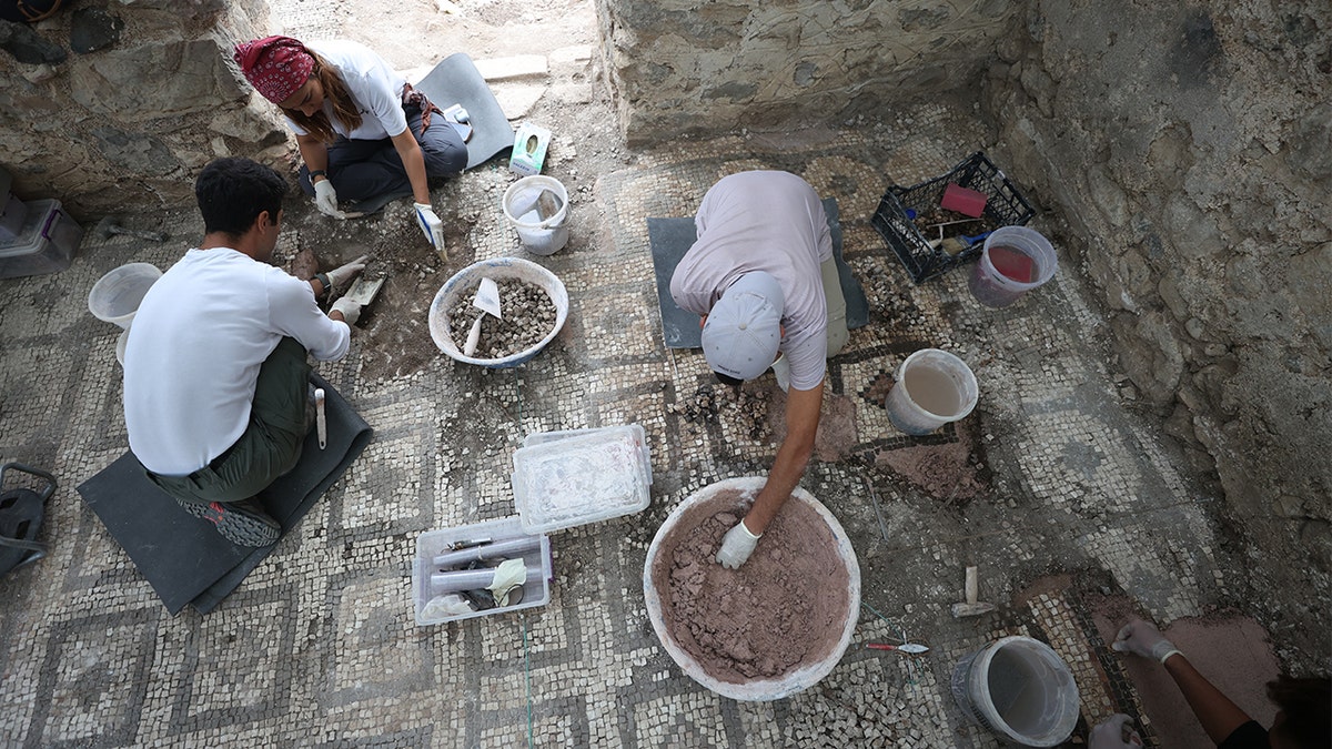 Ancient bishop's luxury bathhouse unearthed in Turkey by archaeologists 2 Archaeologists sifting dirt for artifacts