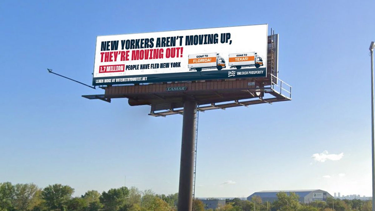 Billboard reads "New Yorkers aren't moving up, they're moving out!"