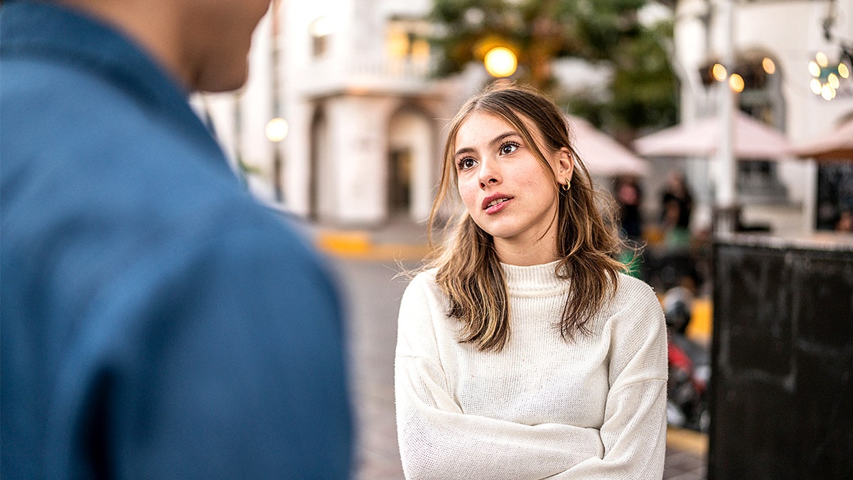 Young couple having an argument outdoors.