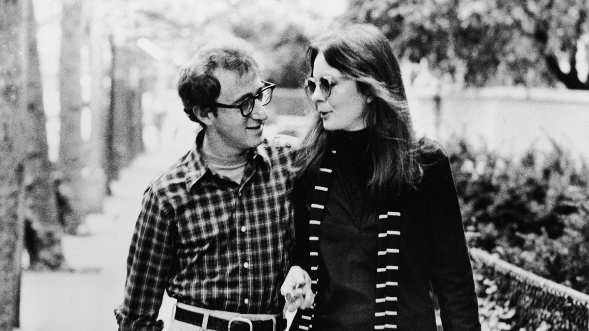 Woody Allen and Diane Keaton look at each other while walking