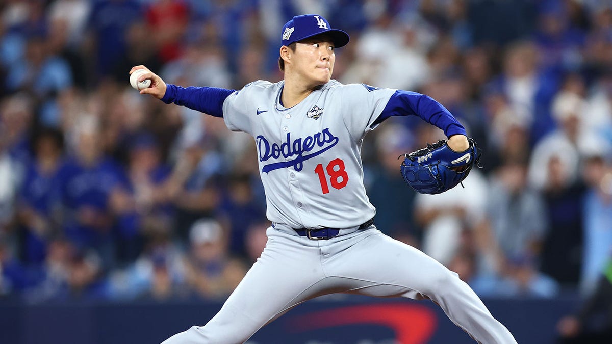 TORONTO, ONTARIO - OCTOBER 25: Yoshinobu Yamamoto #18 of the Los Angeles Dodgers pitches against the Toronto Blue Jays during the first inning in game two of the 2025 World Series at Rogers Center on October 25, 2025 in Toronto, Ontario. (Photo by Vaughn Ridley/Getty Images)