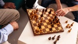 Men playing chess in the living room
