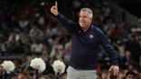 Auburn Tigers head coach Bruce Pearl signaling to players during basketball game.