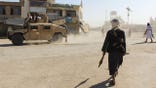 Taliban fighters patrol near border