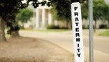 A sign reading "Fraternity" outside a home
