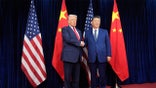 President Donald Trump and Chinese President Xi Jinping shaking hands at Gimhae International Airport in Busan South Korea