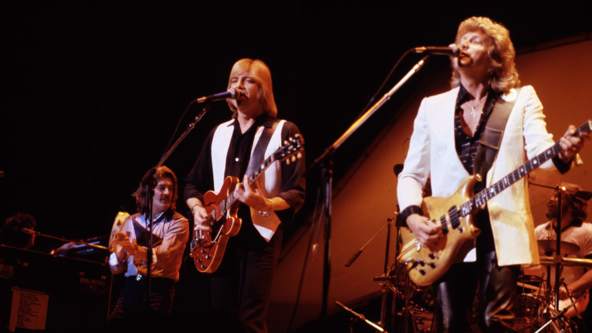 The Moody Blues performing on stage in 1981—left to right: Ray Thomas, Justin Hayward, and John Lodge.