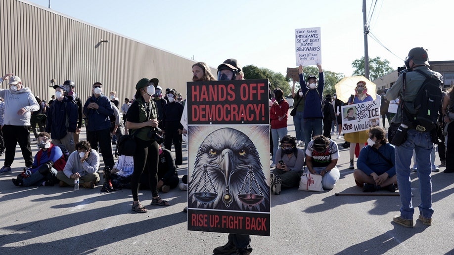 Protesters holding signs outside federal immigration facility