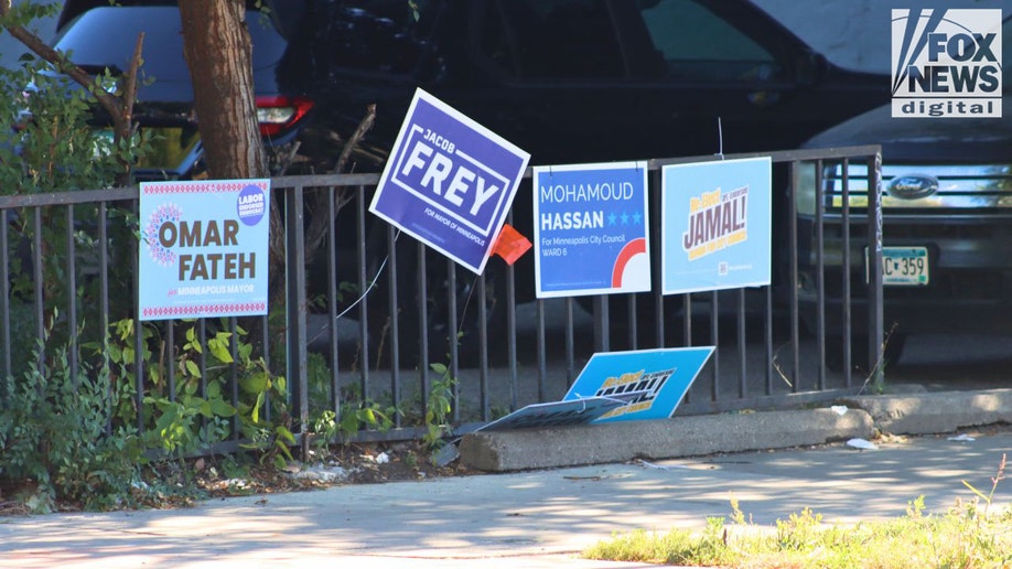 Political campaign signs on fence in Cedar–Riverside Minneapolis