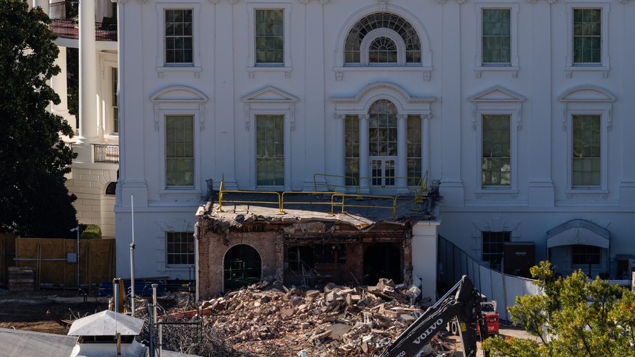 An excavator works to clear rubble after the East Wing of the White House