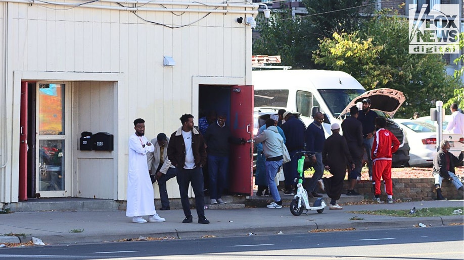Men standing outside mosque entrance in Cedar–Riverside Minneapolis