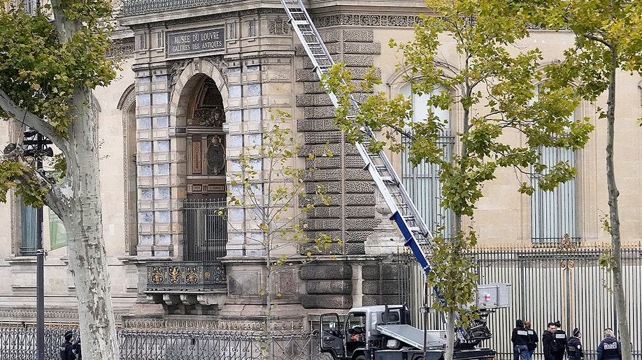 Louvre museum building with ladder leaning up against building