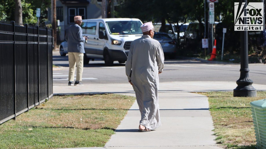 Man walking near Riverside Plaza buildings in Minneapolis