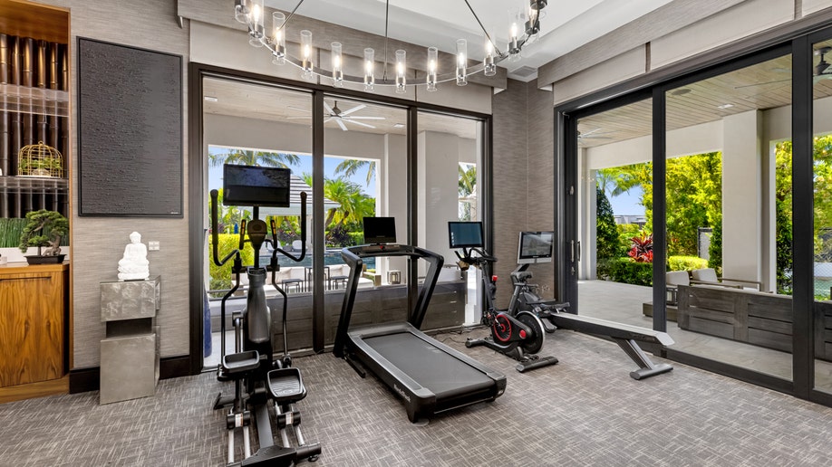 A treadmill and other exercise equipment in Mark Wahlberg's home gym